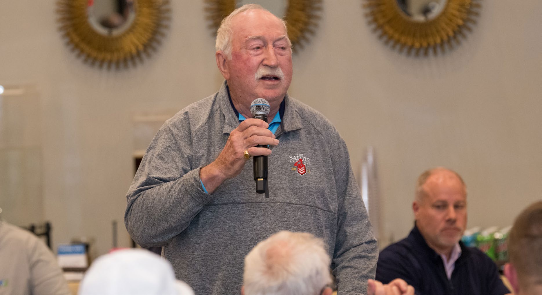 Larry B. Kilmbler speaks at an Envision Dallas golf tournament