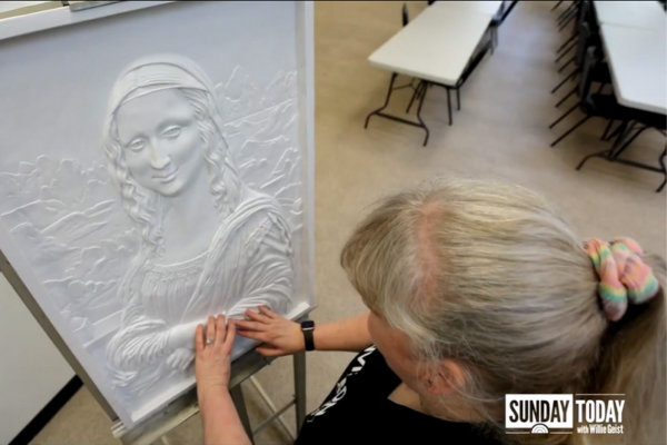 Keela Alonzo touching the tactile Mona Lisa.