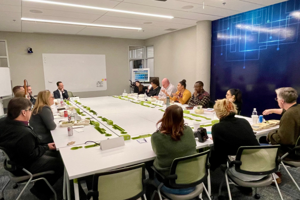 Members of the DEICT forums meeting at a conference room within Envision. 