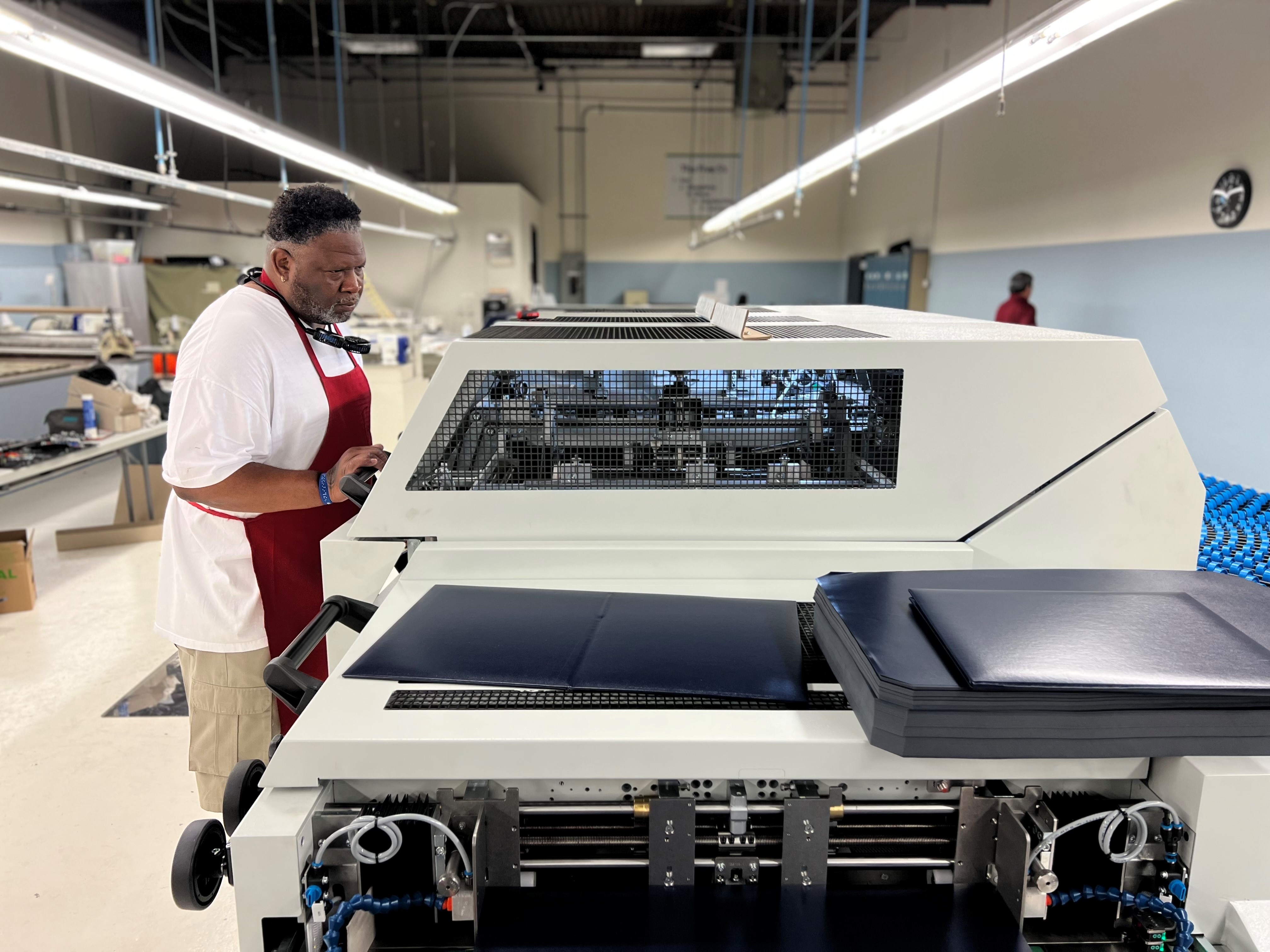 Charles Seville operates the new machinery at the Envision Dallas facility.