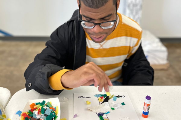 A PRIDE participant making a piece of their art.