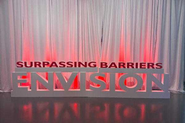 Surpassing Barriers in white letters.