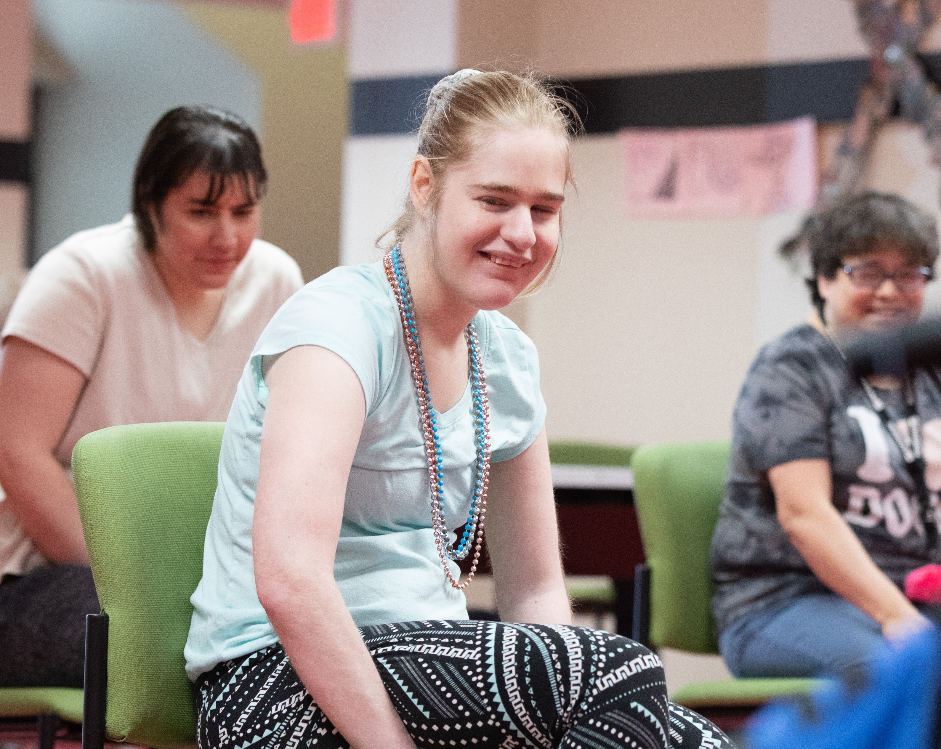 Savannah smiling with her friends in the PRIDE program