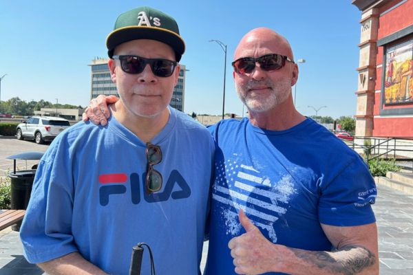 Michael standing with Ray, both smiling for the camera.