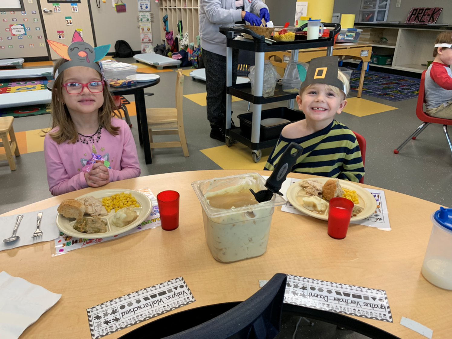 Valynn Walterscheid, Ignatius Vierthaler-Doumit enjoying lunch during ECDC’s Thanksgiving celebratio