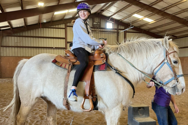 A young girl on a horse.