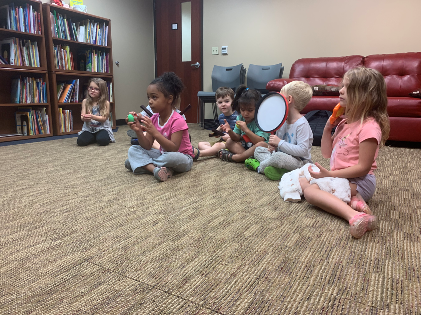 ECDC students sit in new music room and play instruments