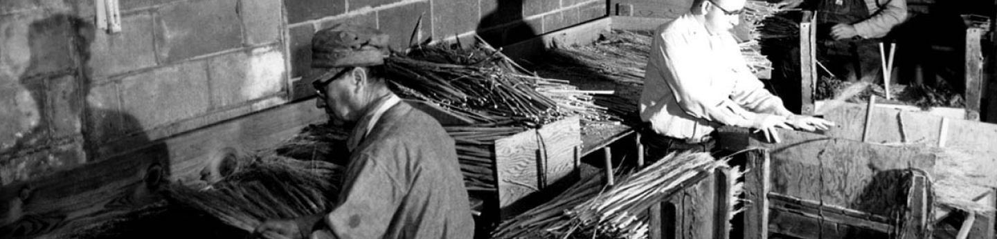 Black and white photo of Wichita workshop and blind employees making brooms during WWII