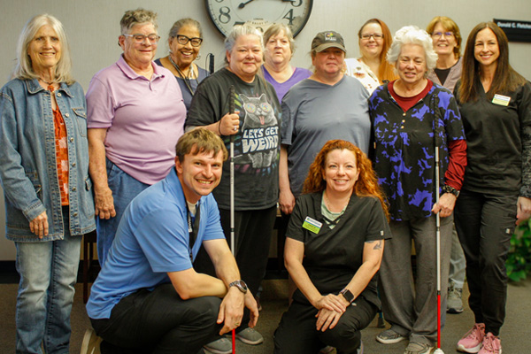 “This Program Changed My Life”: New Envision Initiatives Empower Adults to Thrive Participants in the TIP program stand together for a group photo with EVRC staff.