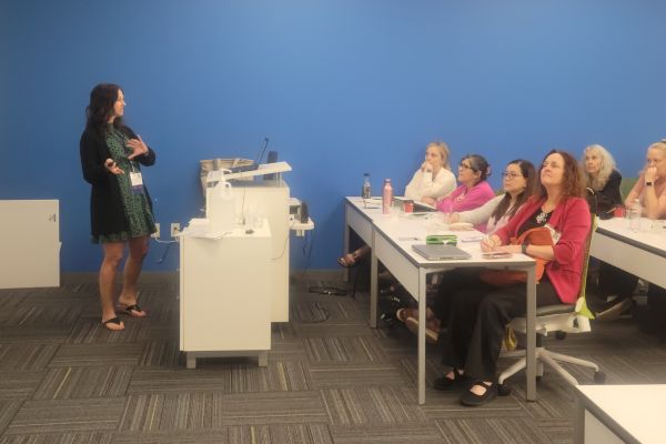 Karen Kendrick, Envision Occupational Therapist teaching a seminar to a classroom full of people.