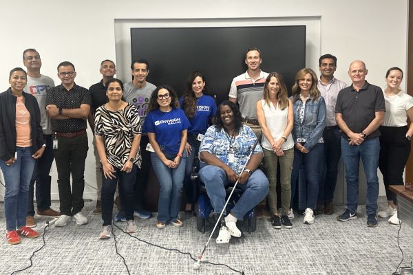 Envision Dallas Gives Presentation on Disability Awareness and Inclusion A group picture of bank of america and Envision employees standing together smiling.