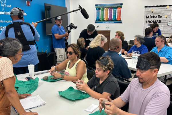 A group of camera crew filming people sculpting at Envision Dallas.