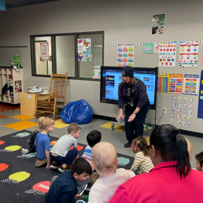 Shannon Ward showing the children how to crawl.