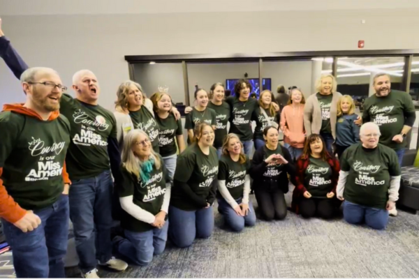 Envision Hosts Watch Party for Miss America Finals Competition A group photo of attendees cheering for Courtney.