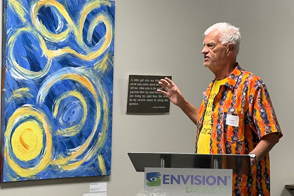 Mendoza speaks to those that attended the VIP event at Envision Dallas