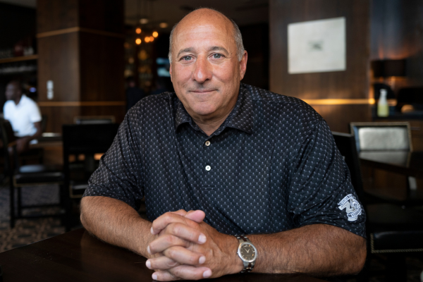 Envision's Milestone Year: Celebrating Our Successes and Milestones in 2023 Michael sitting at a table smiling.