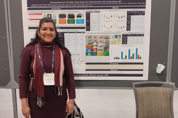 Sarika standing in front of her poster presentation.