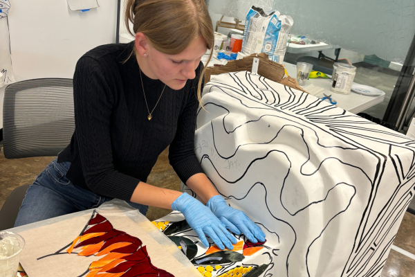 Eva putting stained glass on the Keeper.