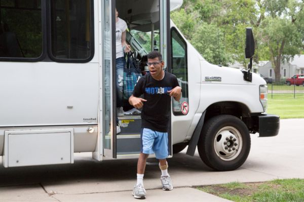 Grant Funding Provides New Van Transportation for Envision P.R.I.D.E. A PRIDE consumer getting off of the van.