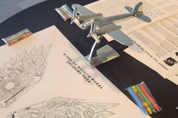 A coloring book on a table that says "Wings of Wichita."