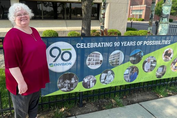 An image of Regina next to the Envision 90th birthday logo