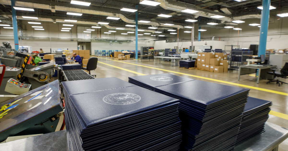 Binders stacked on a table.