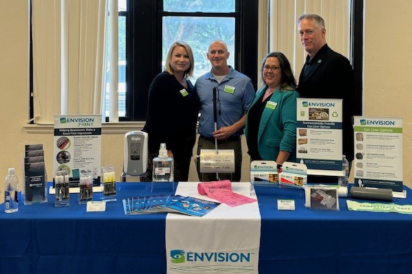 Envision Attends KS State Use Program Committee Meeting & Vendor Fair Marcie Shaffer, Andy Hoffman, Kathy Vines and Buddy Sell standing behind an Envision table.