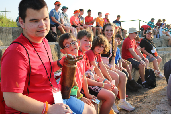 The Freedom of Belonging at Envision’s Heather’s Camp 2024 The boys group at camp smiling around the campfire.