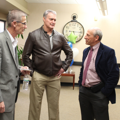 Dr. Fletcher talking to two Envision employees.