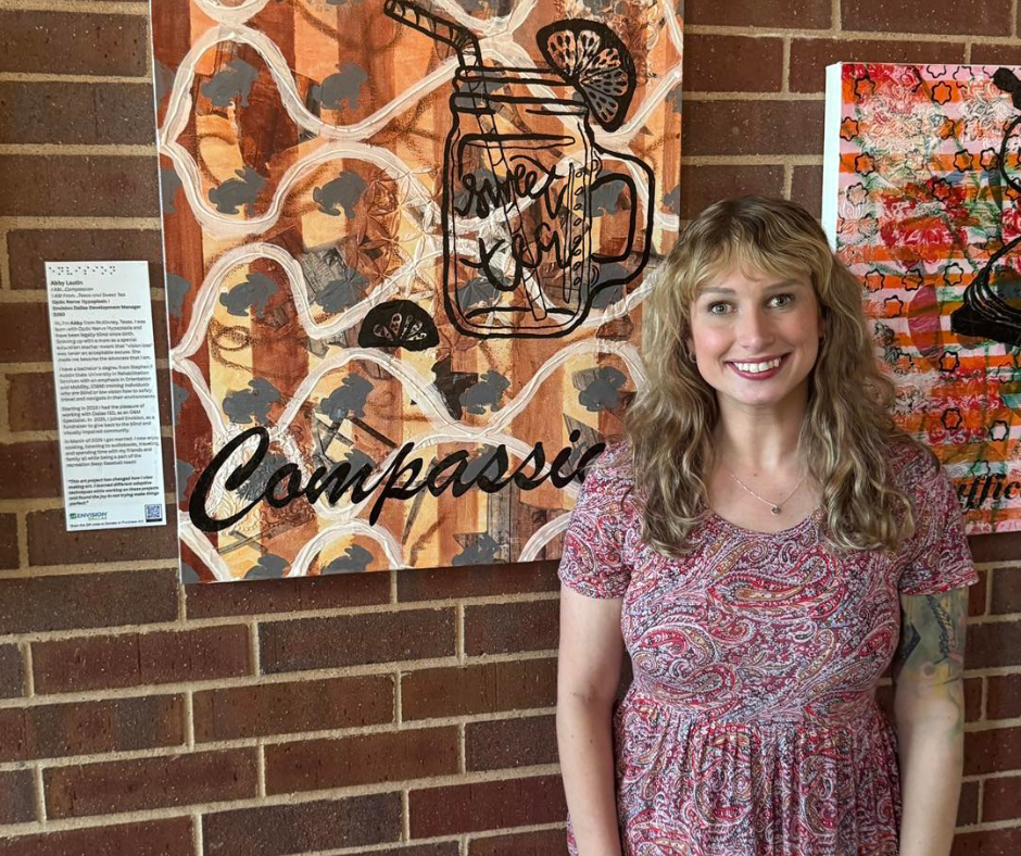 Abby Lautin, Development Manager, stands next to a piece of textured art she created for Envision Da