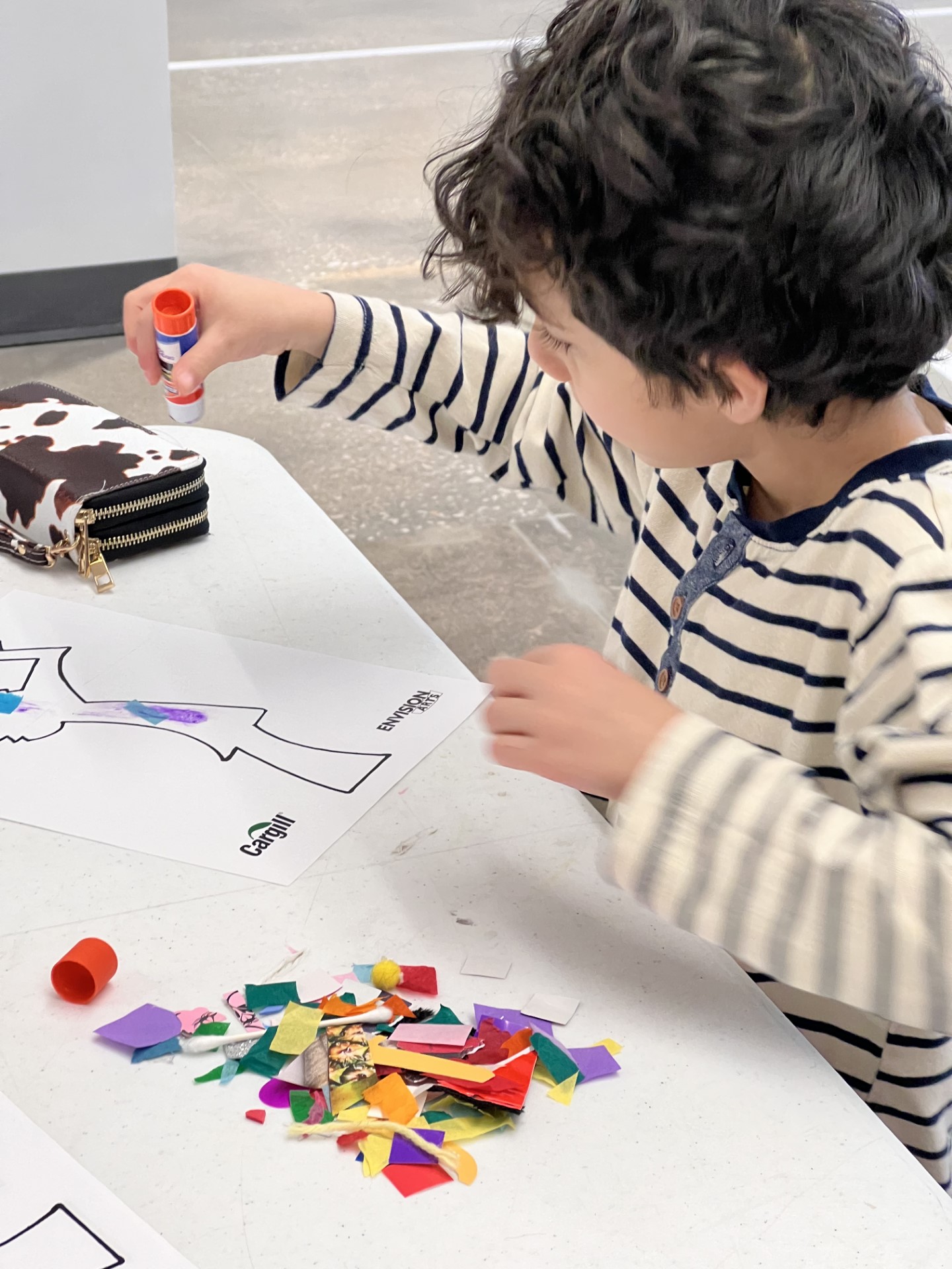 A young child making art.