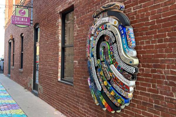 New Artwork by Envision Arts Gallery and Community Organizations Coming Soon A wide shot view of gallery alley with the thumbprint on the wall.