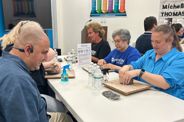 A group of people at sculpting class.