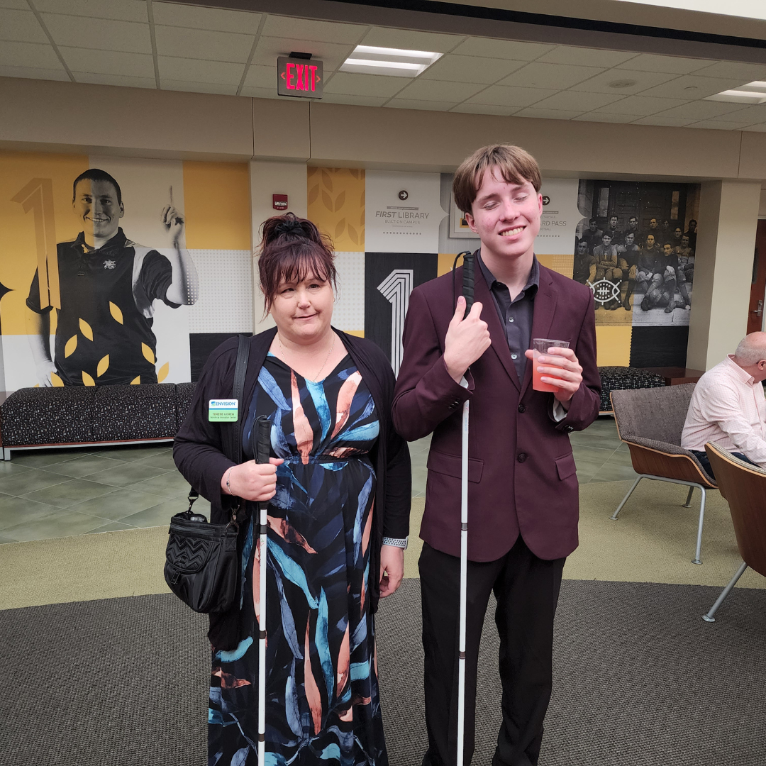 Terese standing with a high school level up student, smiling at the camera. Both are dressed up for the Level Up formal dinner activity.