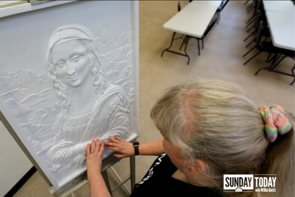Keela Alonzo touching the tactile Mona Lisa.