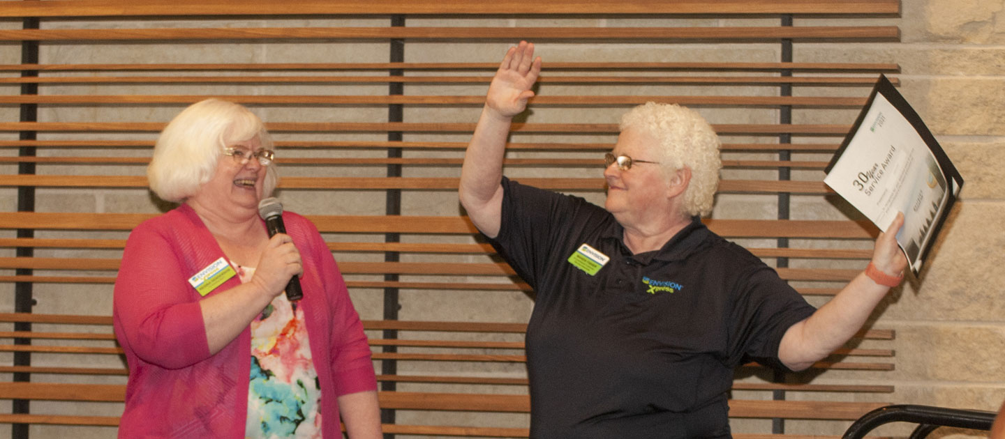 Envision employee Regina celebrates with Wanda her 30 years working for Envision.