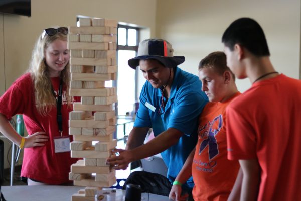 Campers enjoy a game of large block Jenga at Heather's Camp