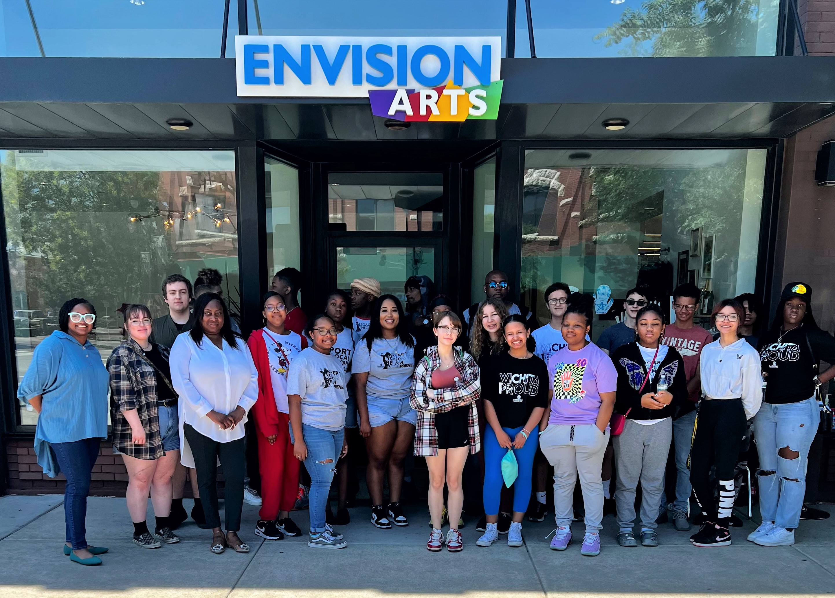 Group of participants standing in front of Envision Arts Gallery Community Center