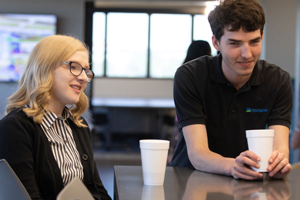 Two people sitting at a table having a conversation