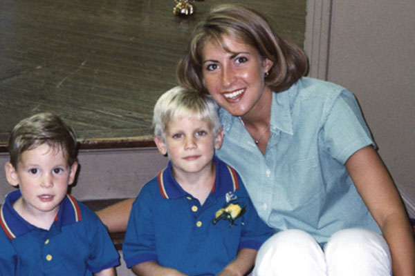 Heather Muller seated with two boys in her preschool class.