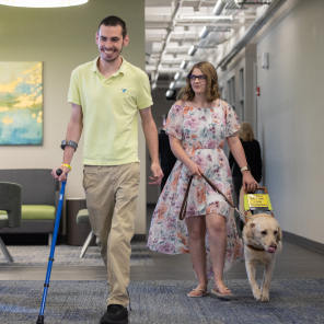 Employees who are B/VI walk together at the BVI Workforce Innovation Center.