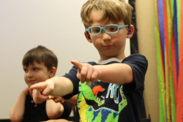 Jackston performing at a an ECDC music class with his friends