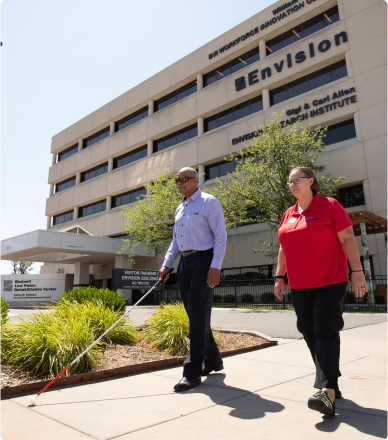 image of a person walking with a white cane.