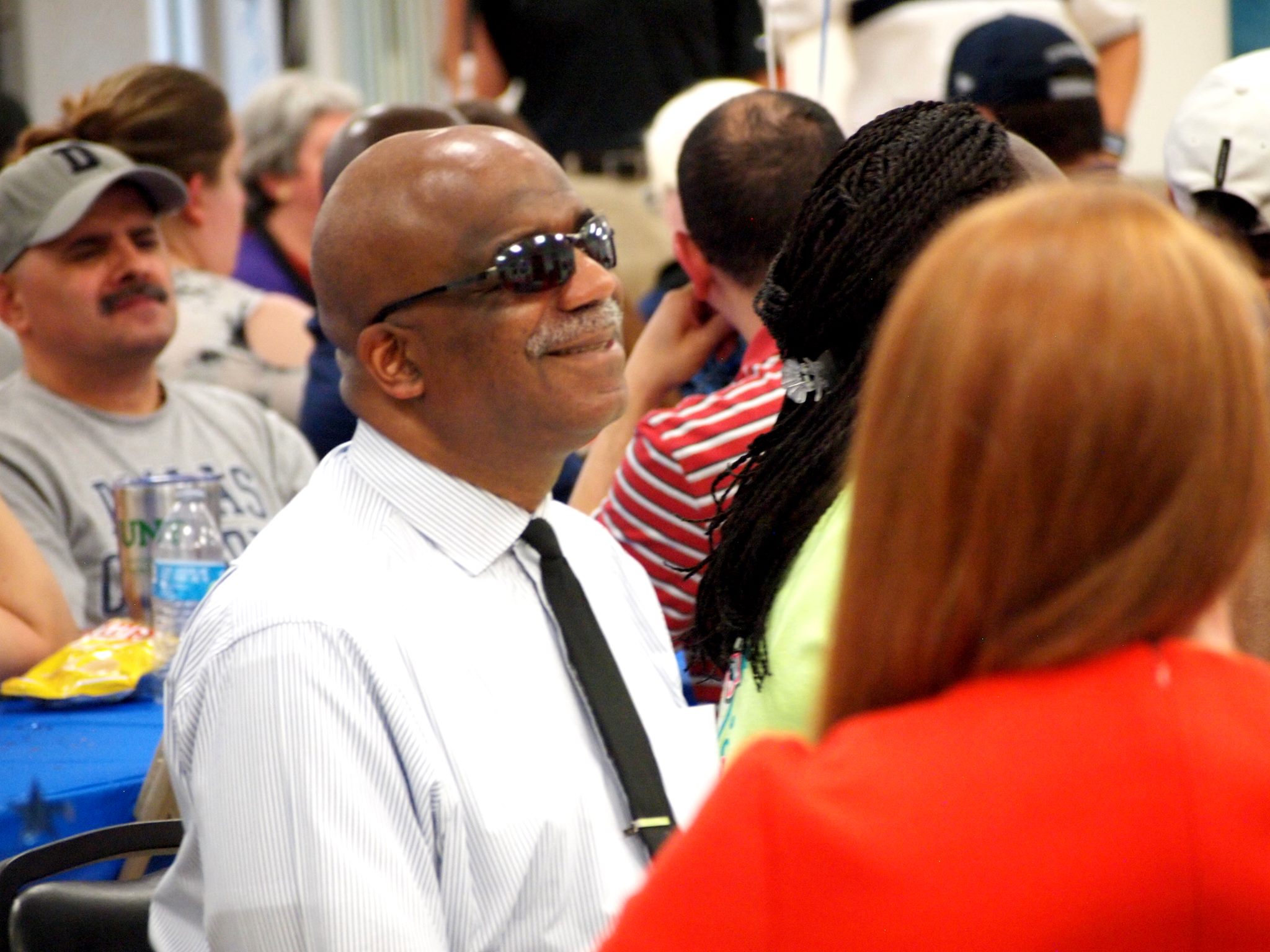 Smiling man who is blind at an Envision event