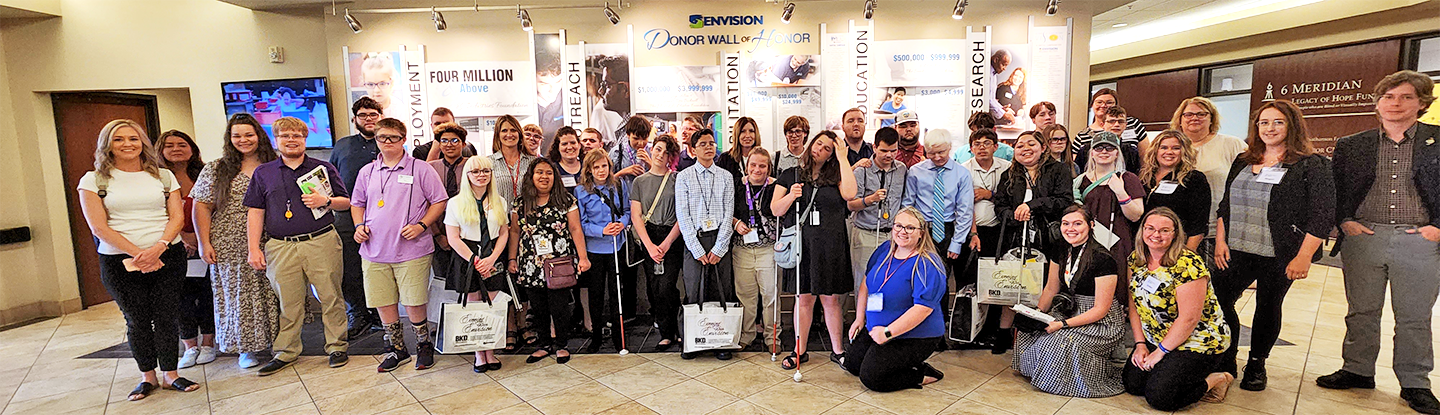 Group shot of Level Up participants standing in the lobby of Envision