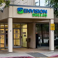 Envision Dallas signage is mounted on the front of the building entrance that was formerly the Dallas Lighthouse for the Blind.