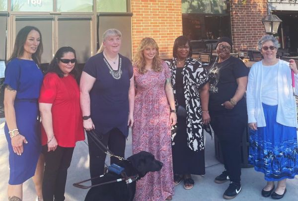 Employees from Envision and Envision Dallas celebrate with Michael Monteferrante on winning their award.