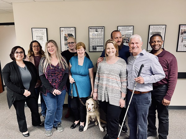 Group of customer service employees at Envision in Wichita standing together for a photo