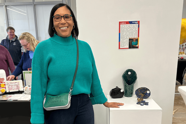 Finding Strength and Community Through Art Linda stands next to her clay creations at the Holiday Art market at the Envision Arts Gallery.