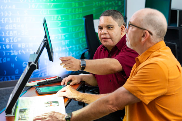 Man who is visually impaired receives instructions at the Assistive Technology Lab in Dallas.